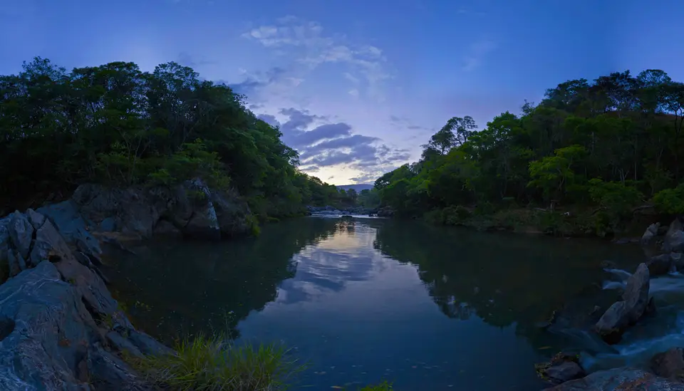 Wide-angle view of a river through the Brazilian forest at dusk